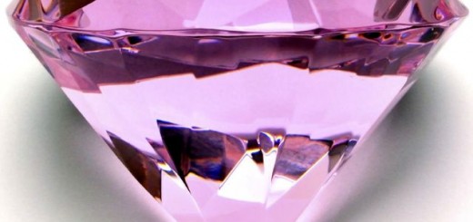 Close-up of a large pink gem on a white background.
